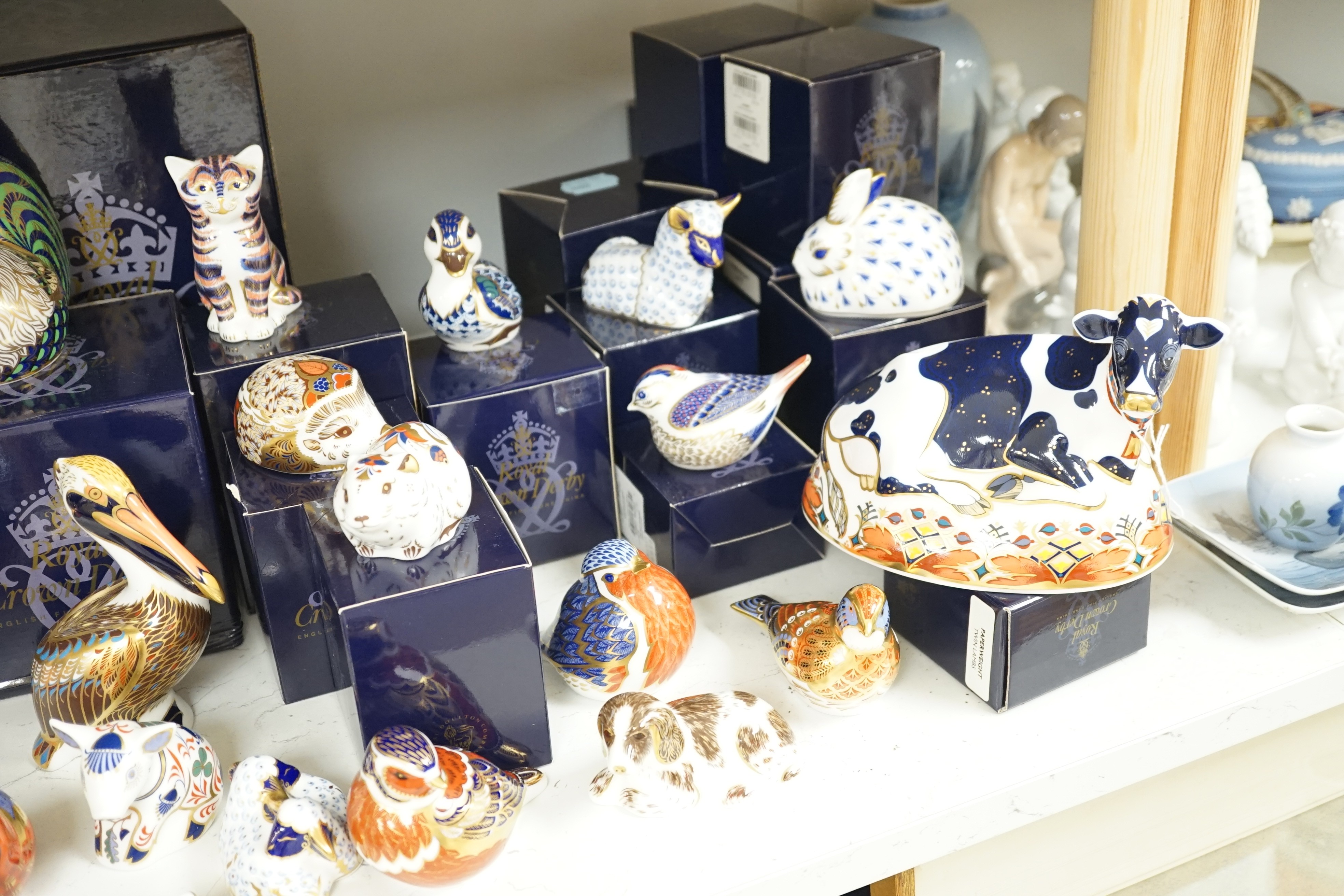Approximately thirty-two Royal Crown Derby Imari porcelain paperweights, all but two with original boxes and mostly gold bottoms